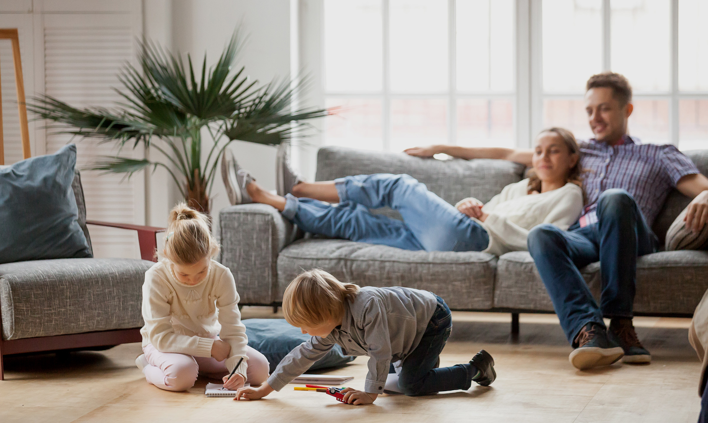 Family sitting in living room inside comfortable home